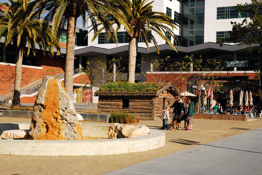 family walking dog near fountain