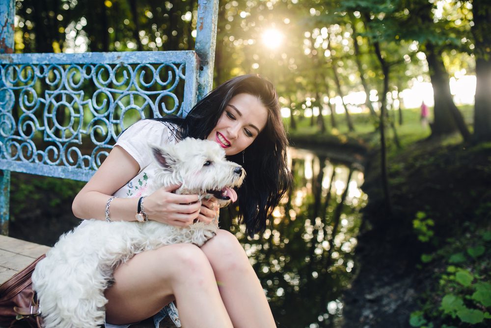 girl with dog at river